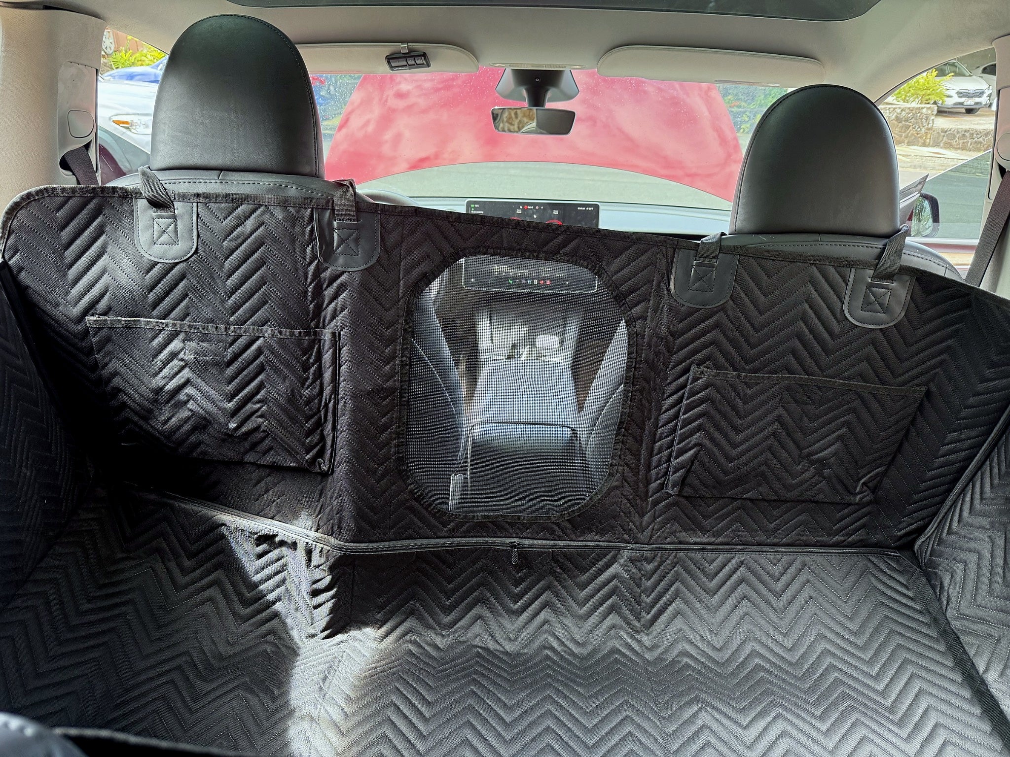 Interior view of dog backseat extender with mesh window and storage pockets