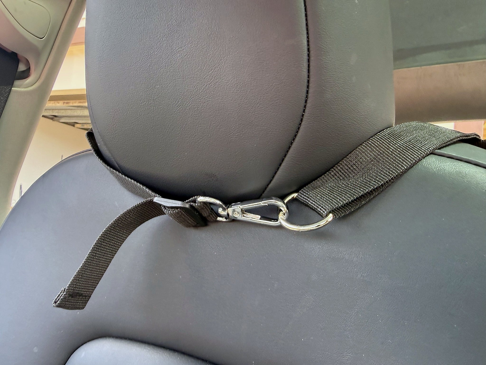 Headrest strap and metal clip attachment