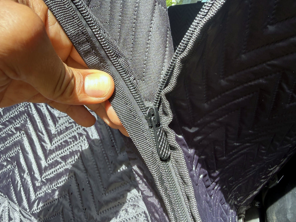 Zipper connecting the side panel to the backseat extender