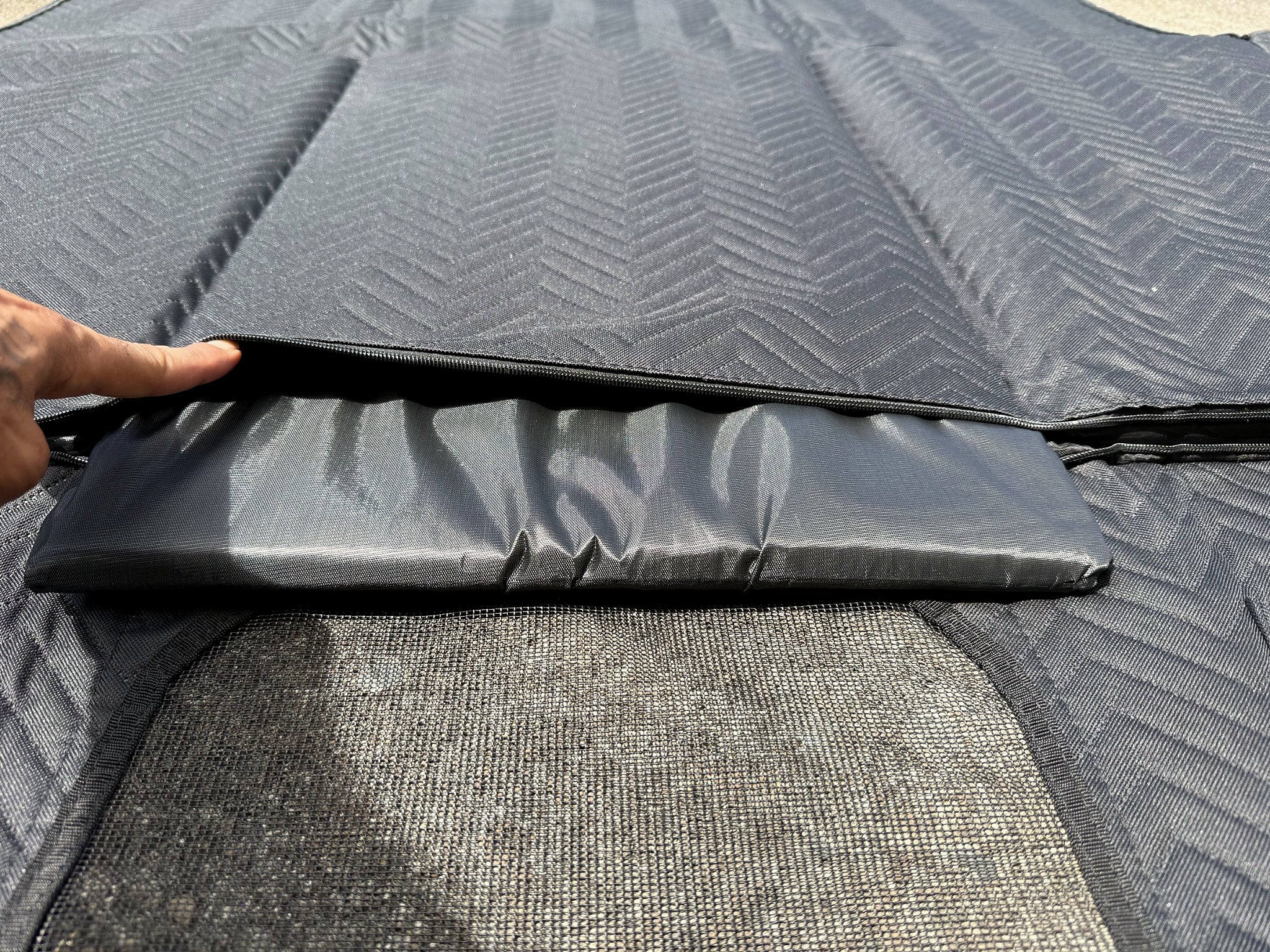 Hard support panel being inserted into the zippered base