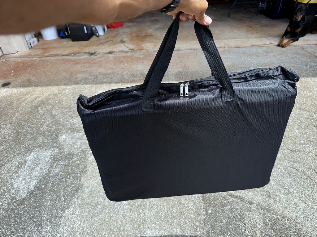 Folded dog backseat extender inside its carrying bag